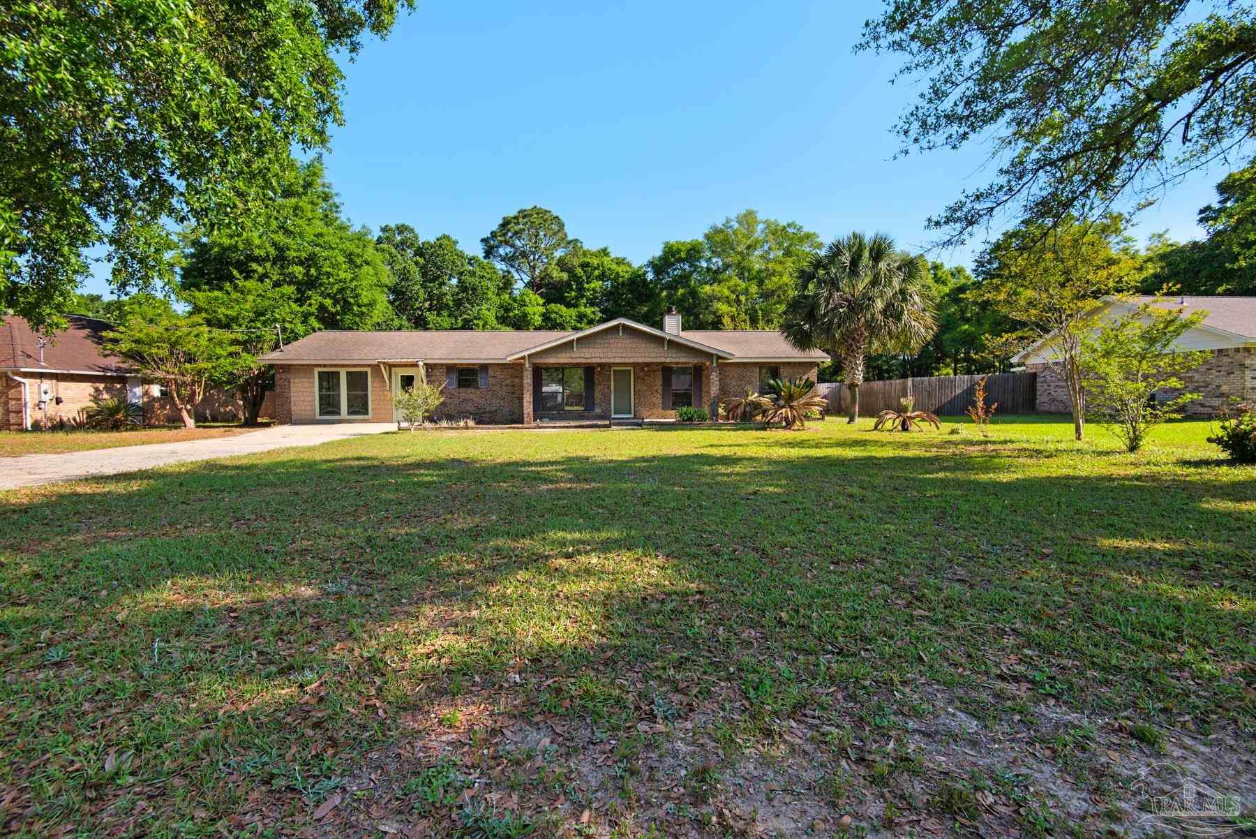 5804 Gulf Road Milton, FL 32583 - Photo 5 of 54 a house view with swimming pool and garden space