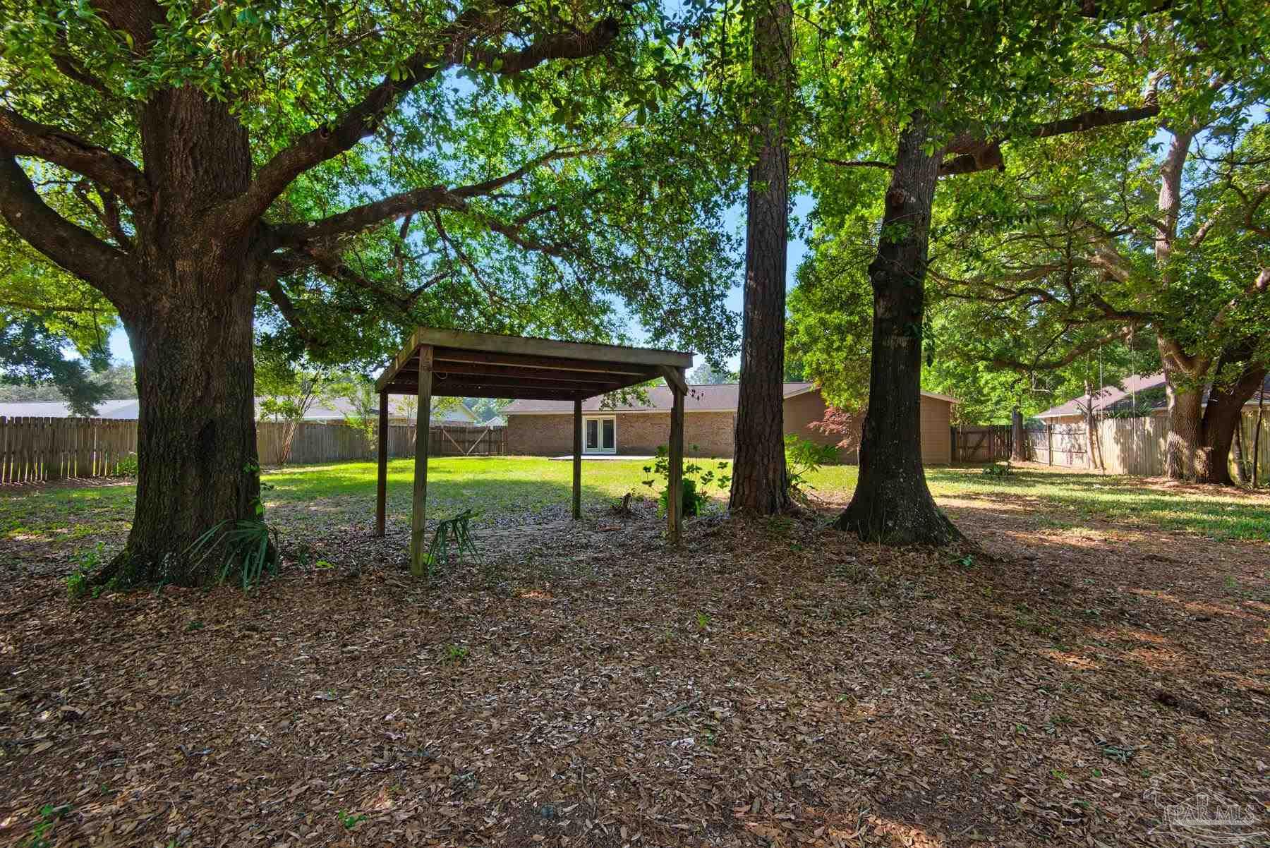 5804 Gulf Road Milton, FL 32583 - Photo 53 of 54 a view of a yard with a trees