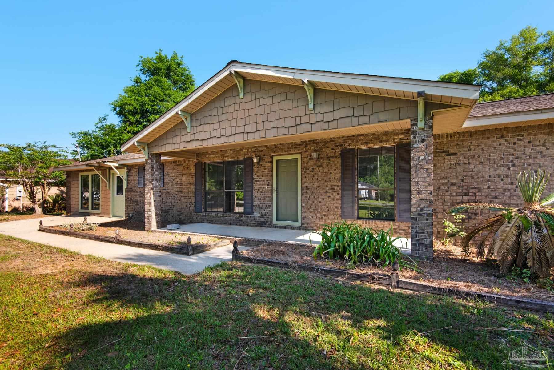 5804 Gulf Road Milton, FL 32583 - Photo 8 of 54 a front view of a house with a yard