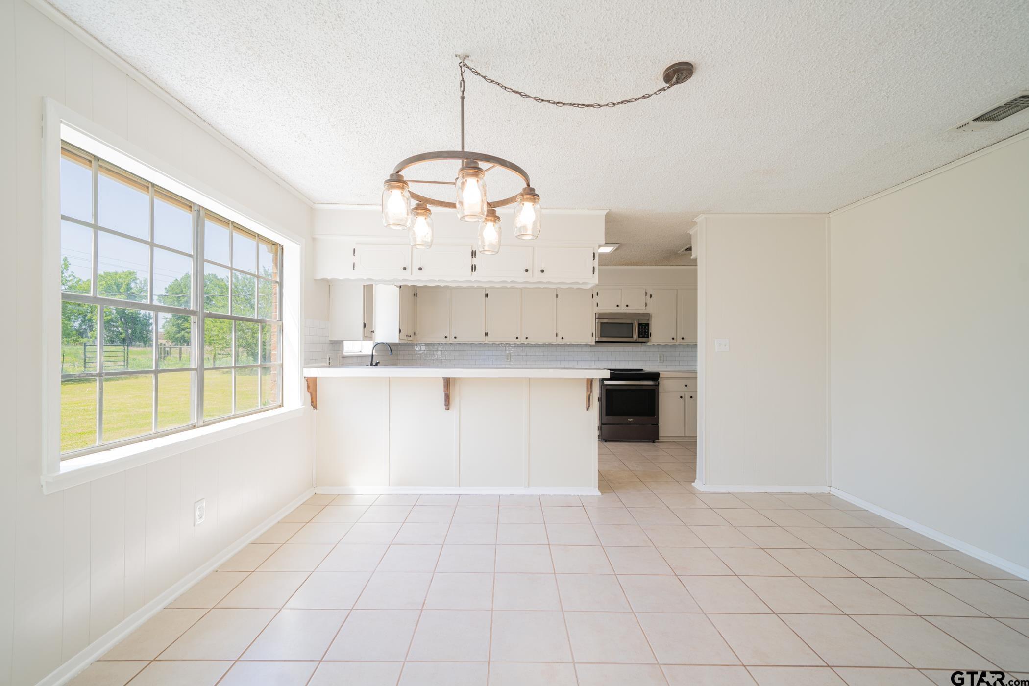 1332 Cr 4840 Mount Mount Pleasant, TX 75455 - Photo 13 of 38 a large white kitchen with a large window