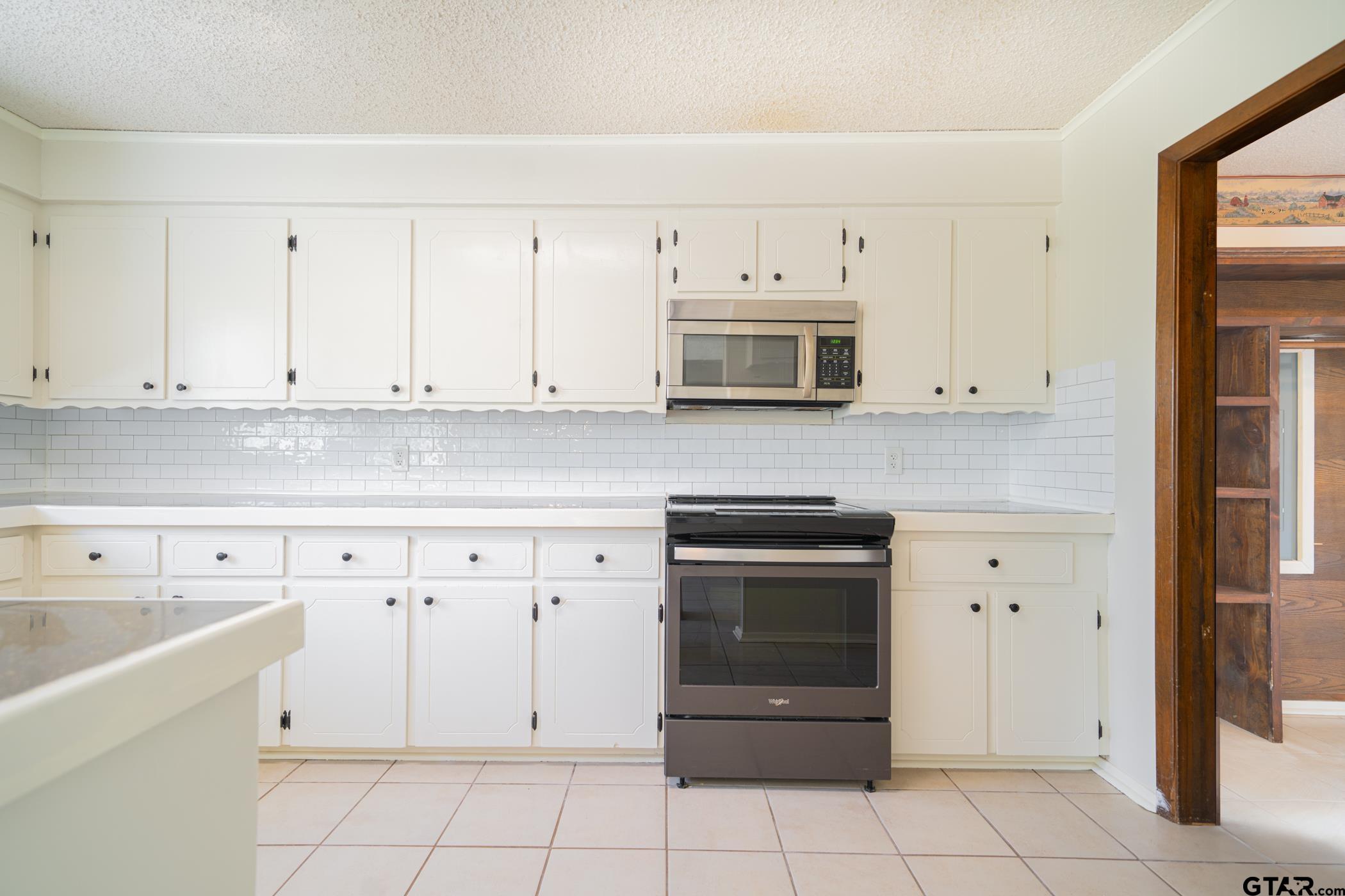 1332 Cr 4840 Mount Mount Pleasant, TX 75455 - Photo 14 of 38 a kitchen with cabinets appliances and a sink