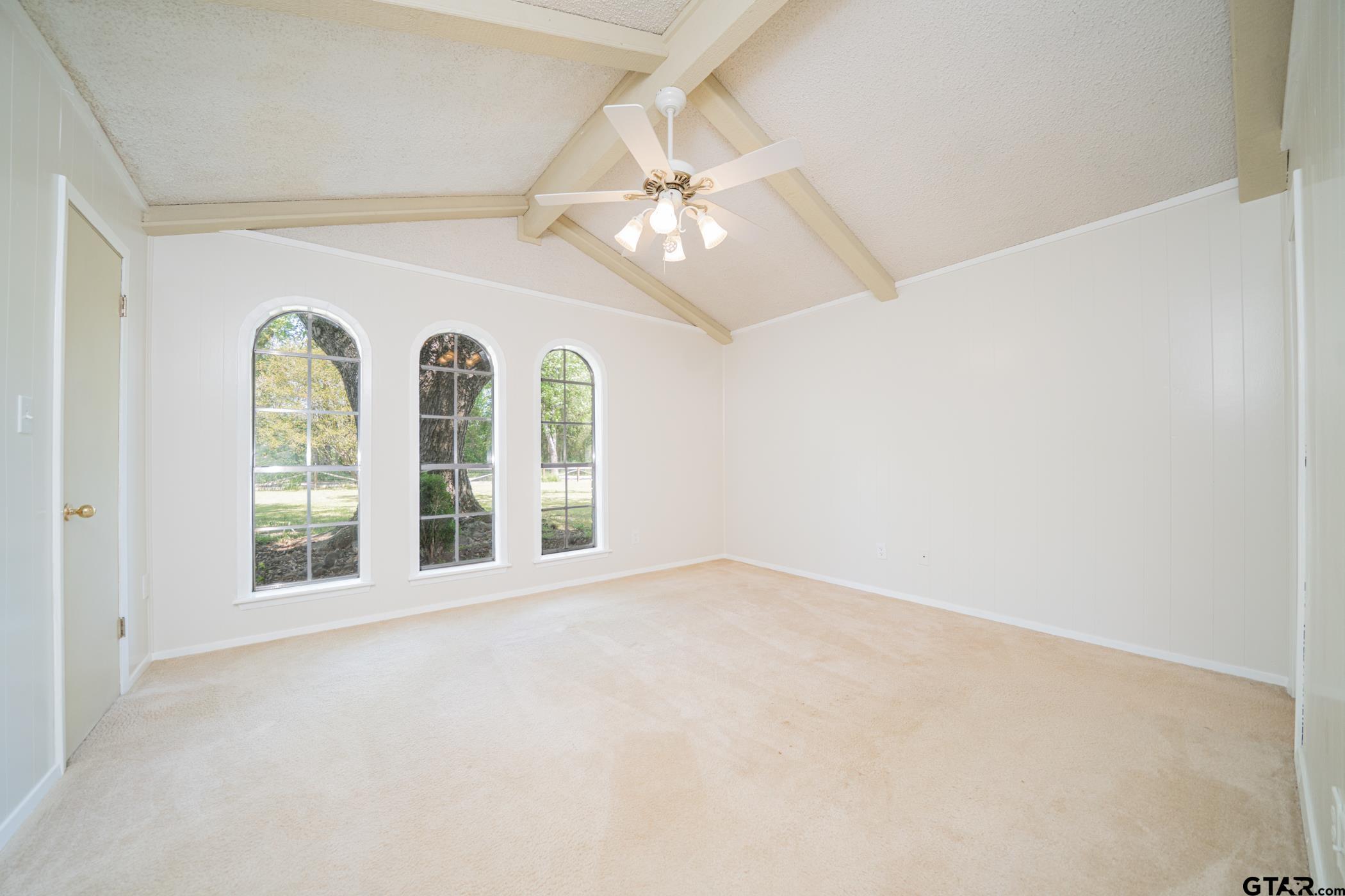 1332 Cr 4840 Mount Mount Pleasant, TX 75455 - Photo 22 of 38 an empty room with windows and ceiling fan