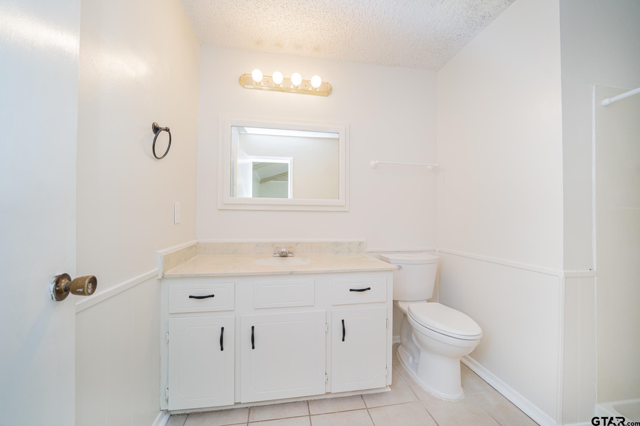 1332 Cr 4840 Mount Mount Pleasant, TX 75455 - Photo 24 of 38 a bathroom with a sink a toilet and a mirror