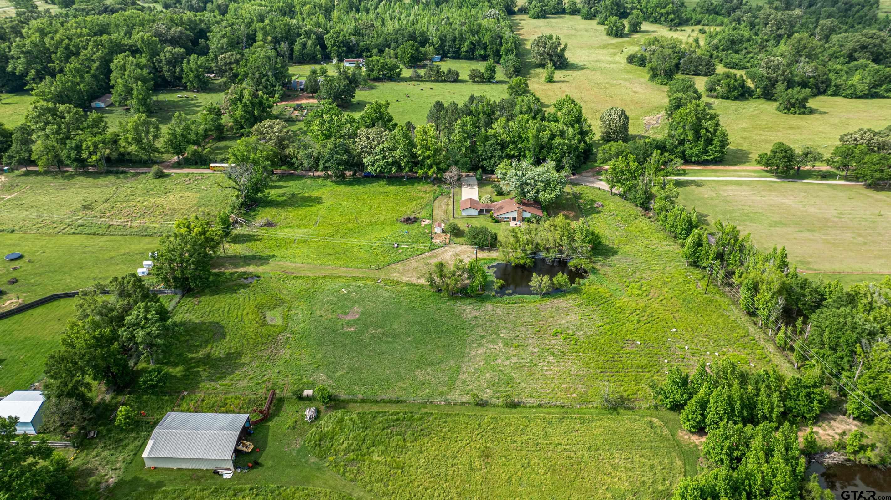 1332 Cr 4840 Mount Mount Pleasant, TX 75455 - Photo 36 of 38 an aerial view of residential houses with outdoor space and trees