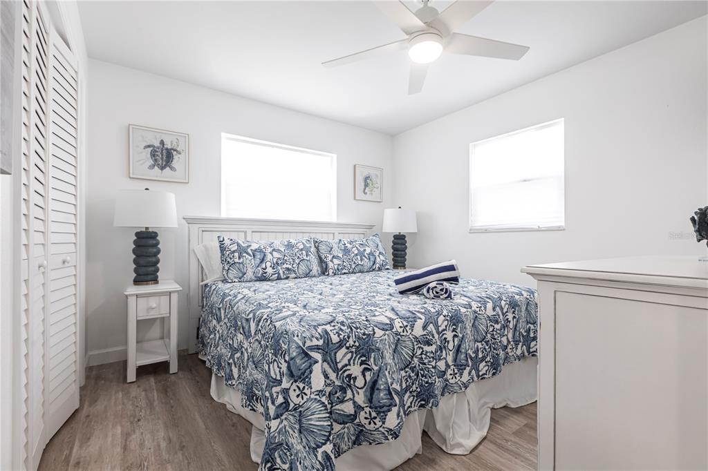 6020 Midnight Pass Road, Unit 7 Sarasota, FL 34242 - Photo 11 of 18 a bed sitting in a bedroom next to a window