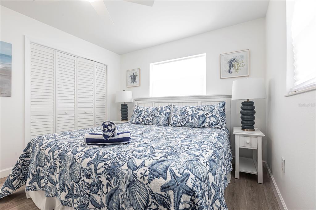 6020 Midnight Pass Road, Unit 7 Sarasota, FL 34242 - Photo 12 of 18 a bedroom with a bed and a window