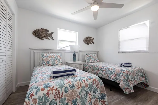 a bedroom with two beds and a chandelier