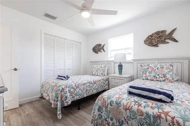 a bedroom with two beds and a large mirror