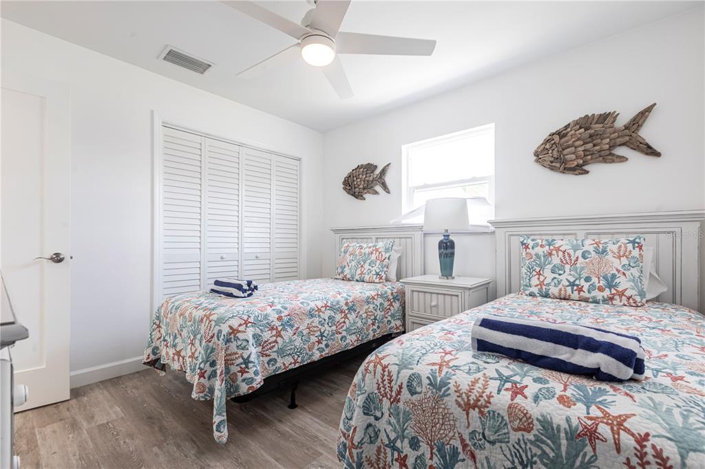 6020 Midnight Pass Road, Unit 7 Sarasota, FL 34242 - Photo 14 of 18 a bedroom with two beds and a large mirror