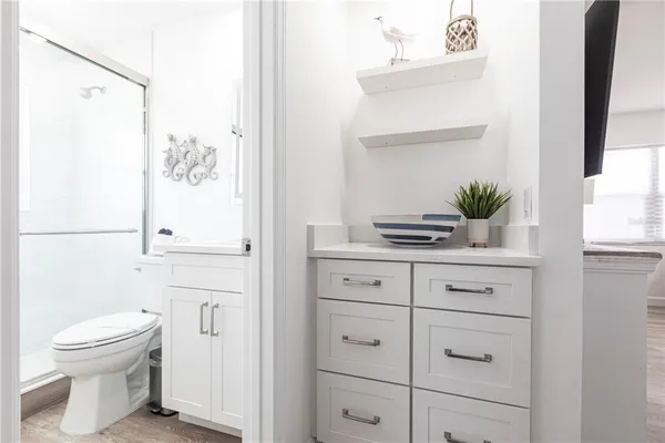 a bathroom with a sink a toilet and shower