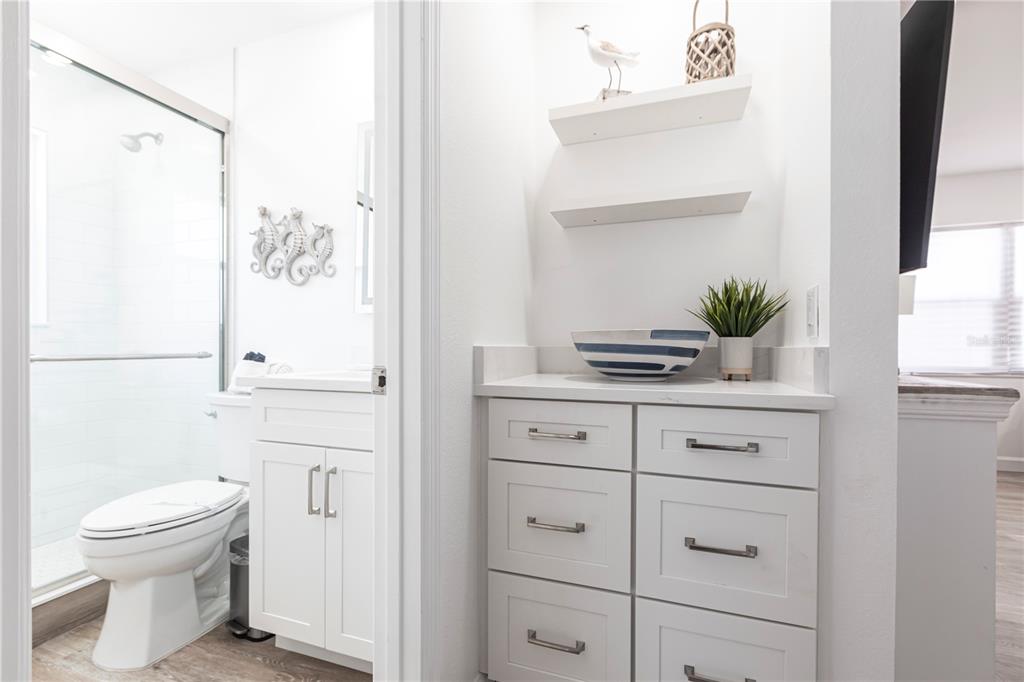 6020 Midnight Pass Road, Unit 7 Sarasota, FL 34242 - Photo 8 of 18 a bathroom with a sink a toilet and shower