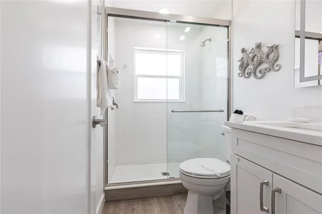 a bathroom with a sink a toilet and shower