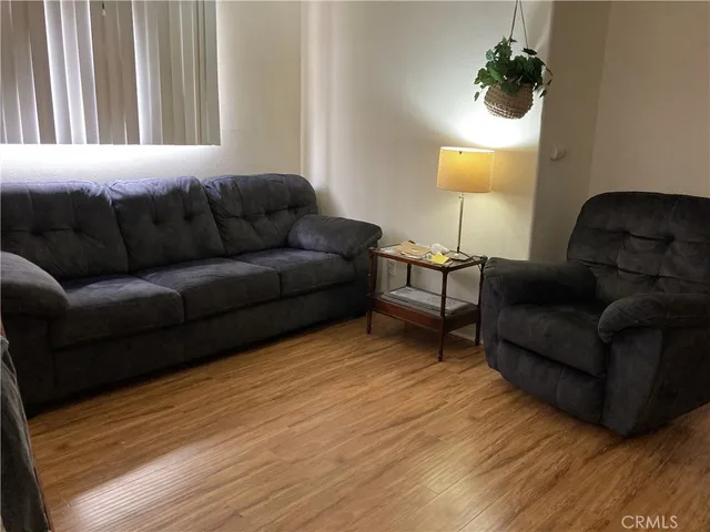 a living room with furniture and a lamp