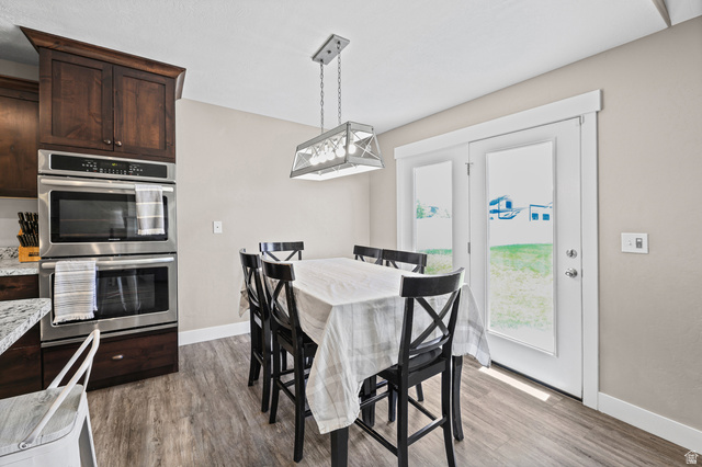 712 East Sunset View Road Grantsville, UT 84029 - Photo 17 of 44 Large semi-formal dining area with french doors out a beautiful backyard.