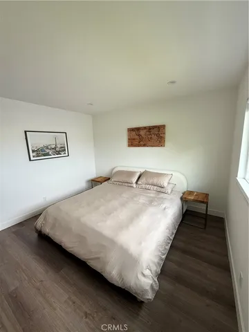 a bedroom with bed and painting on the wall
