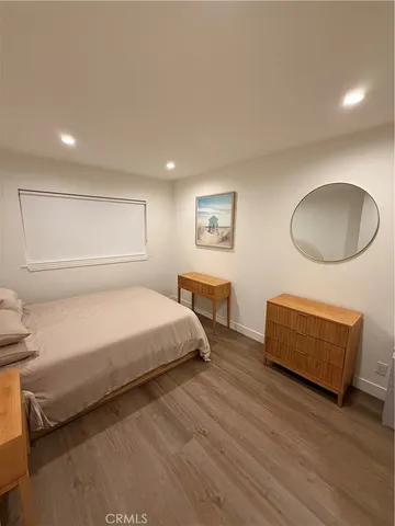 a spacious bedroom with a bed and a chair