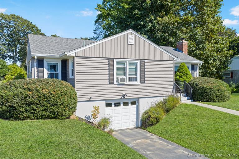 Welcome to this inviting one-story ranch showcasing freshly painted gray siding.