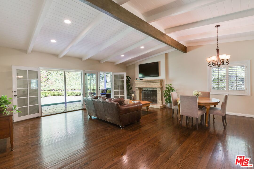 811 Jacon Way Pacific Palisades, CA 90272 - Photo 3 of 25 a living room with fireplace furniture and a wooden floor