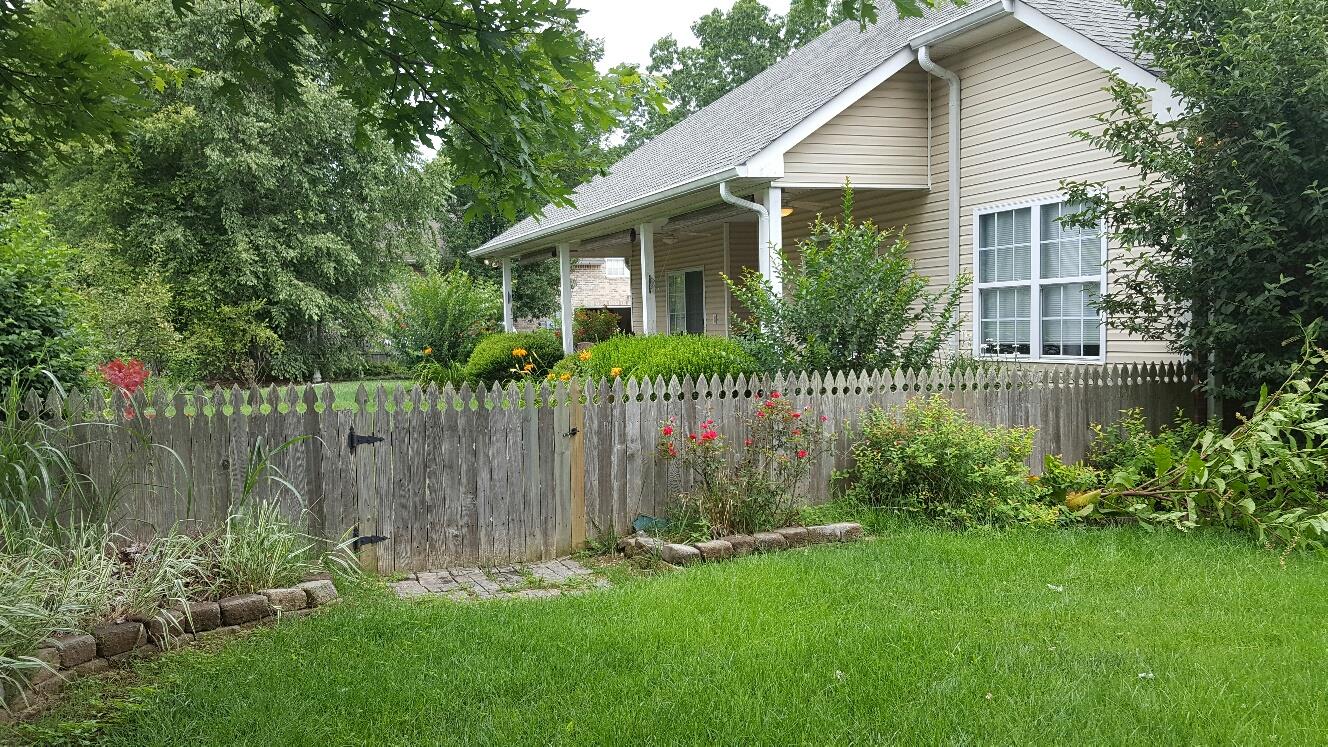 7118 Fernvale Road Fairview, TN 37062 - Photo 11 of 29 a front view of a house with a garden and plants