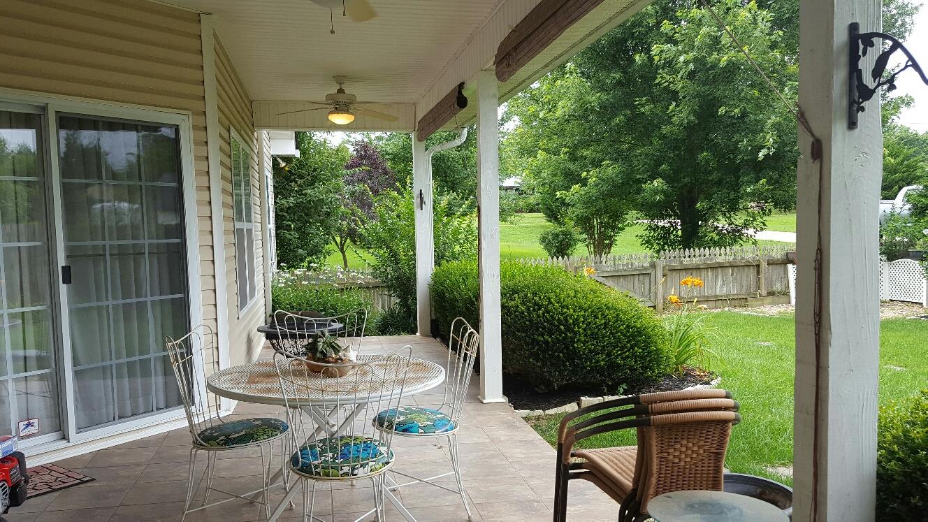 7118 Fernvale Road Fairview, TN 37062 - Photo 7 of 29 a view of a patio with table and chairs potted plants with large tree
