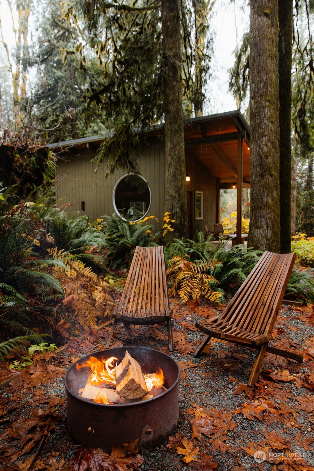 51822 South Riverside Road Gold Bar, WA 98251 - Photo 6 of 40 a backyard of a house with barbeque oven table and chairs