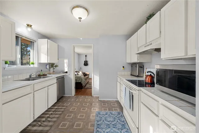 a kitchen with a sink and cabinets