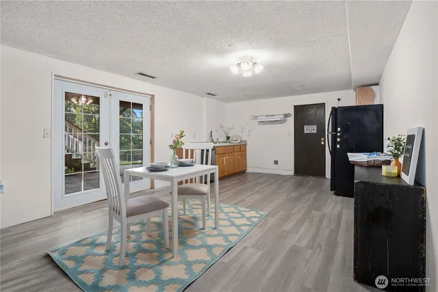 a dining room with furniture and wooden floor