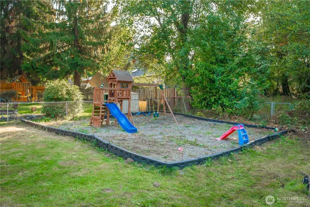 a view of a backyard with swimming pool