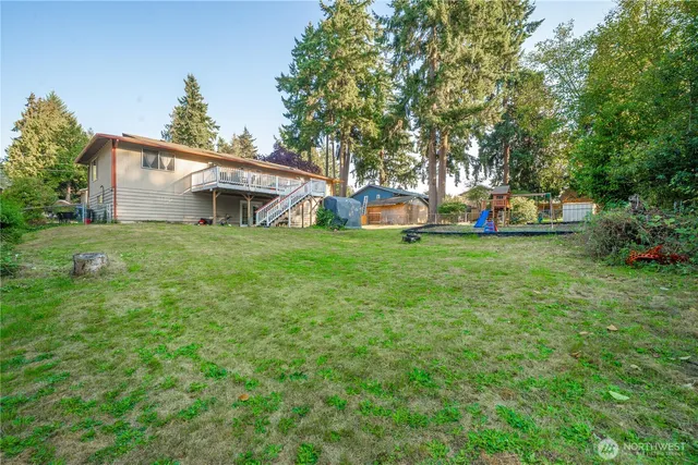 a view of a house with backyard and sitting area