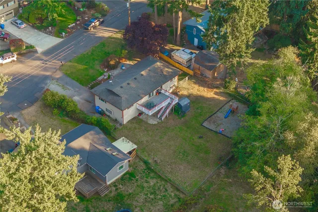 an aerial view of a house with garden space and street view