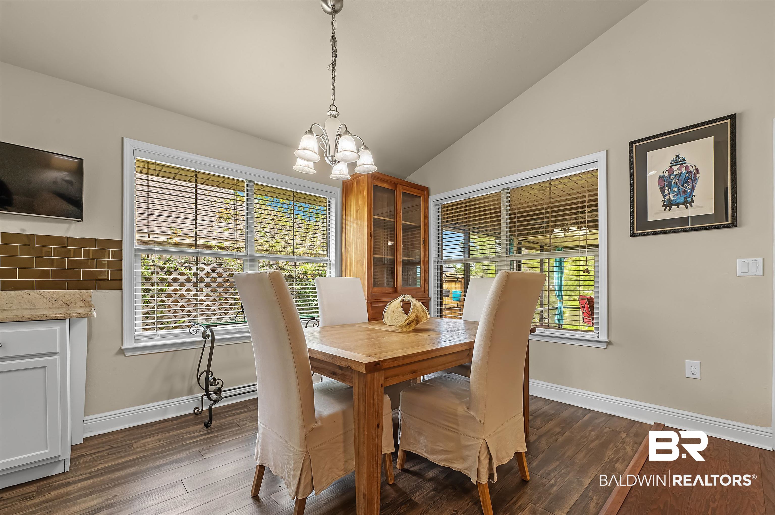 8896 Allay Lane Foley, AL 36535 - Photo 33 of 57 Dining room with lofted ceiling, an inviting chandelier, and dark hardwood / wood-style flooring