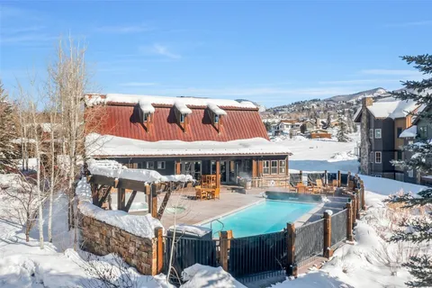 a view of a terrace with chairs and wooden fence