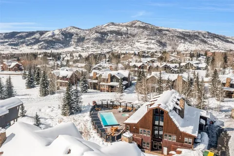 a room with pool table and windows