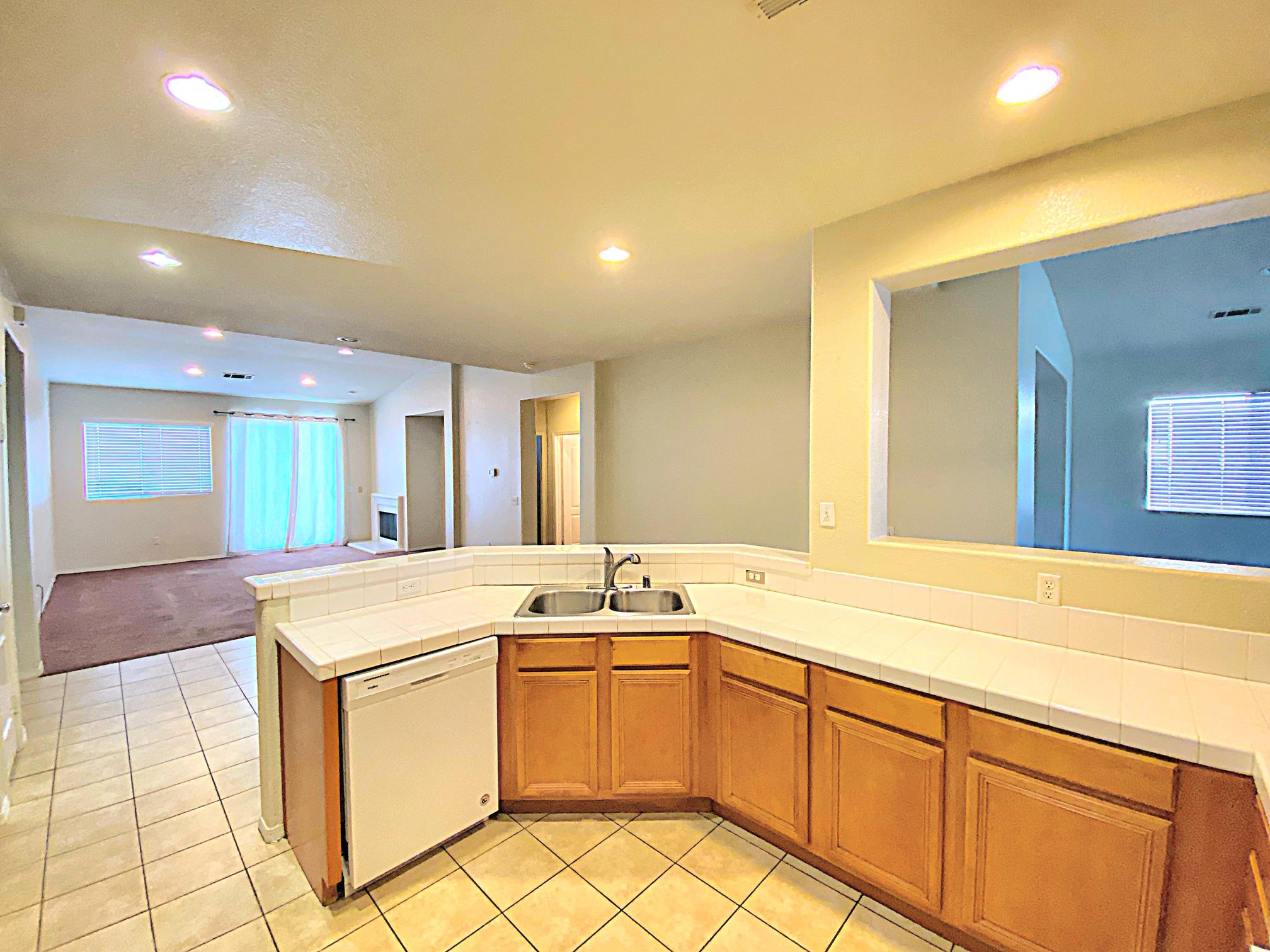 2751 Garnet Lane Lancaster, CA 93535 - Photo 23 of 46 a kitchen that has a sink and a stove in it