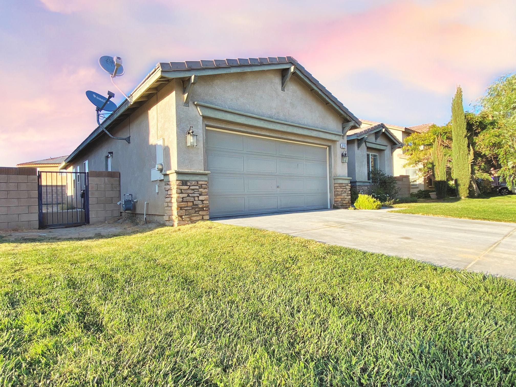 2751 Garnet Lane Lancaster, CA 93535 - Photo 4 of 46 a front view of a house with a yard