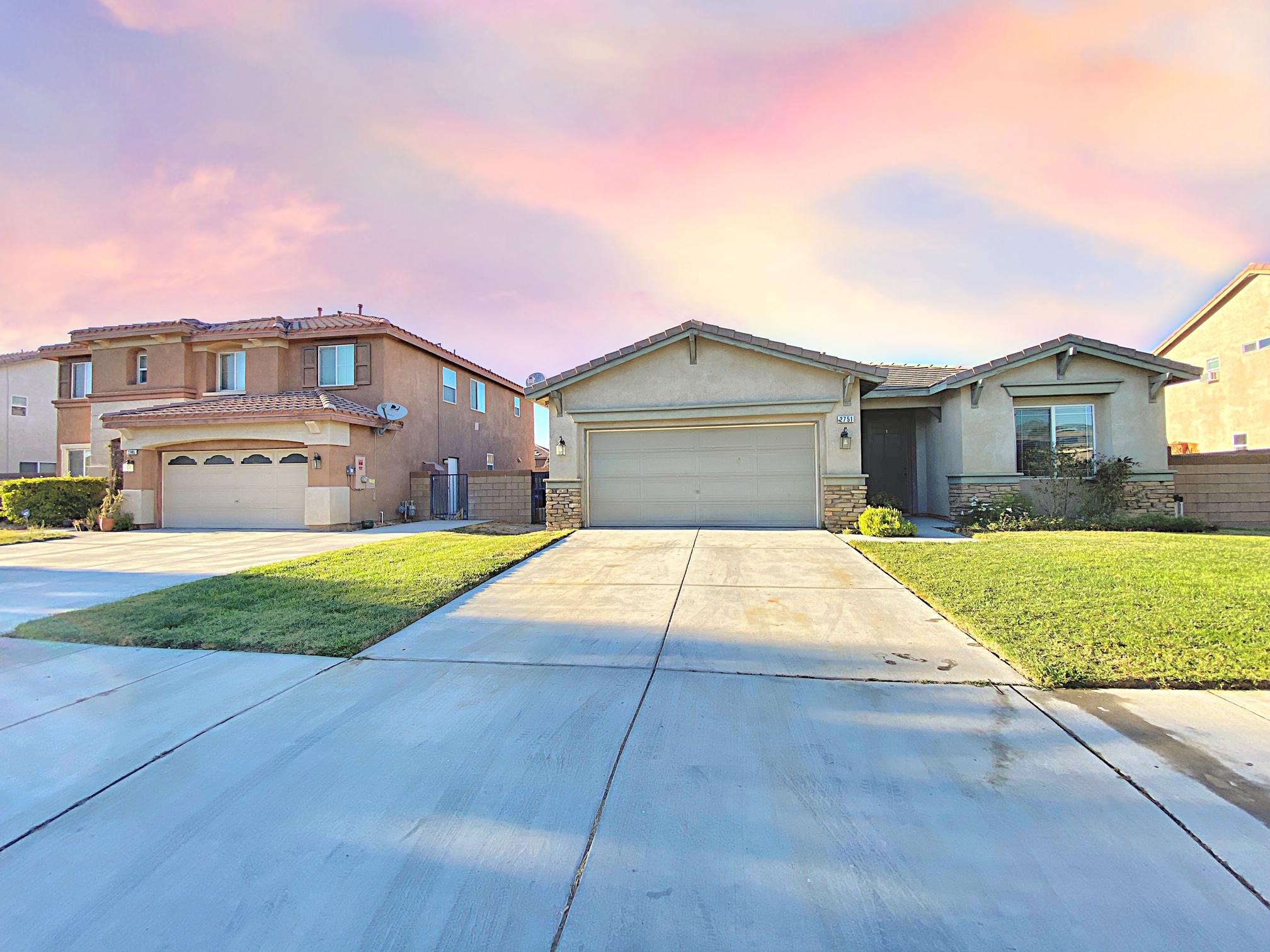 2751 Garnet Lane Lancaster, CA 93535 - Photo 7 of 46 a front view of a house with a yard and garage
