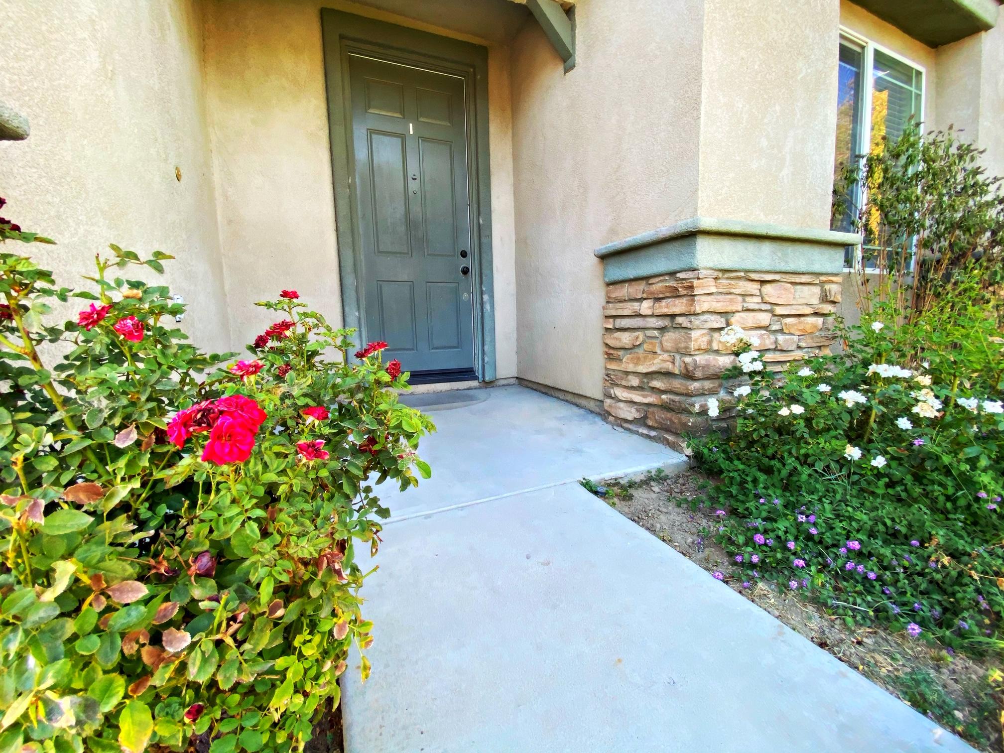 2751 Garnet Lane Lancaster, CA 93535 - Photo 9 of 46 a view of a pathway with a flower garden