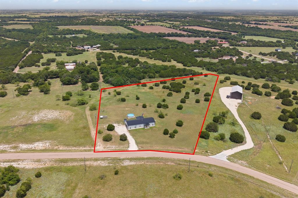 1031 Augustus Court Rio Vista, TX 76093 - Photo 27 of 30 Expansive rural property featuring a single-story residence with a dark roof and a circular above-ground pool