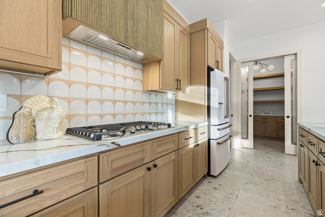 226 East 1100 North Hurricane, UT 84737 - Photo 22 of 49 Kitchen featuring decorative backsplash, high end white refrigerator, stainless steel gas cooktop, light stone countertops, and light floors
