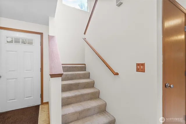 an empty room with a window and a ceiling fan