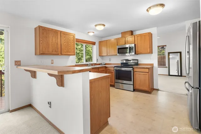 a kitchen with a sink stove top oven and cabinets