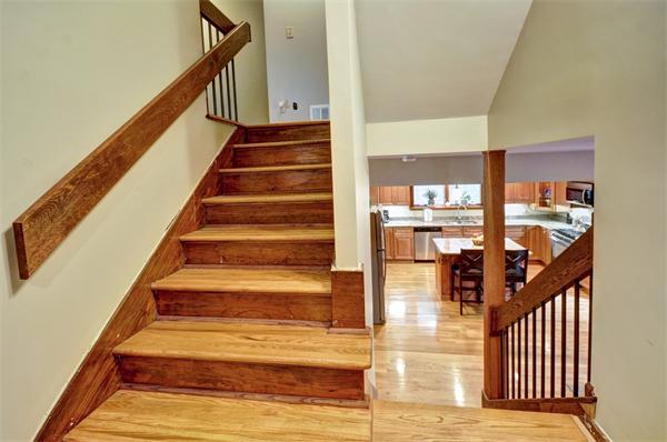 119 Pecunit Street Canton, MA 02021 - Photo 14 of 28 a view of staircase with lots of frames on wall and a large window