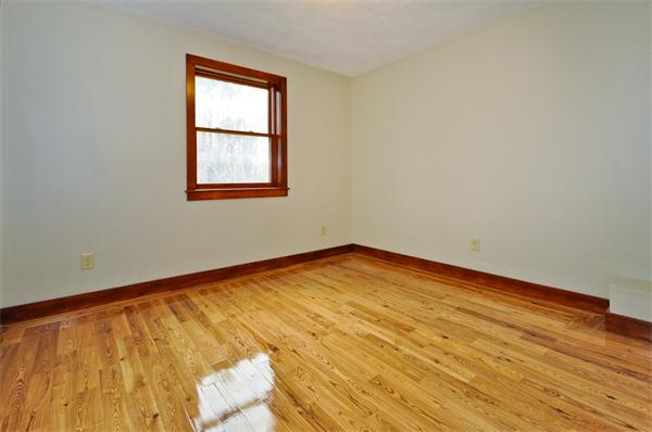 119 Pecunit Street Canton, MA 02021 - Photo 19 of 28 an empty room with wooden floor and windows