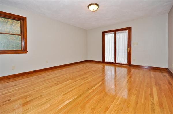 119 Pecunit Street Canton, MA 02021 - Photo 20 of 28 an empty room with wooden floor and windows