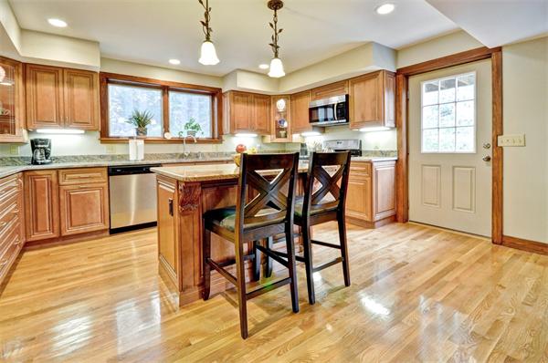 119 Pecunit Street Canton, MA 02021 - Photo 2 of 28 a kitchen with stainless steel appliances granite countertop table chairs sink refrigerator and microwave