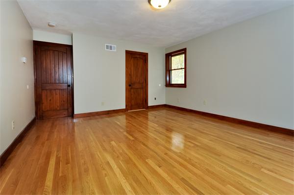 119 Pecunit Street Canton, MA 02021 - Photo 21 of 28 a view of an empty room with wooden floor and a window