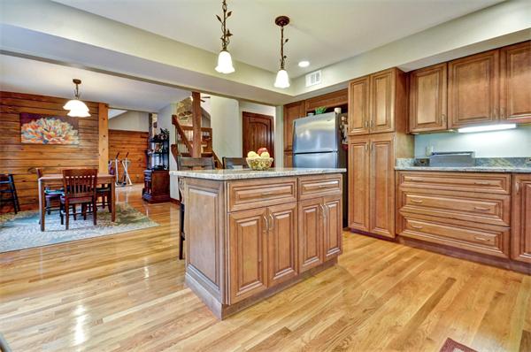 119 Pecunit Street Canton, MA 02021 - Photo 5 of 28 a kitchen with stainless steel appliances granite countertop a refrigerator a sink dishwasher a dining table and chairs with wooden floor