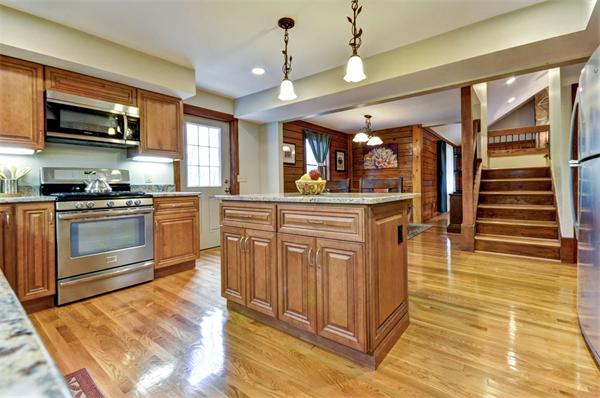 119 Pecunit Street Canton, MA 02021 - Photo 6 of 28 a kitchen with stainless steel appliances granite countertop a stove top oven a sink dishwasher a dining table and chairs with wooden floor