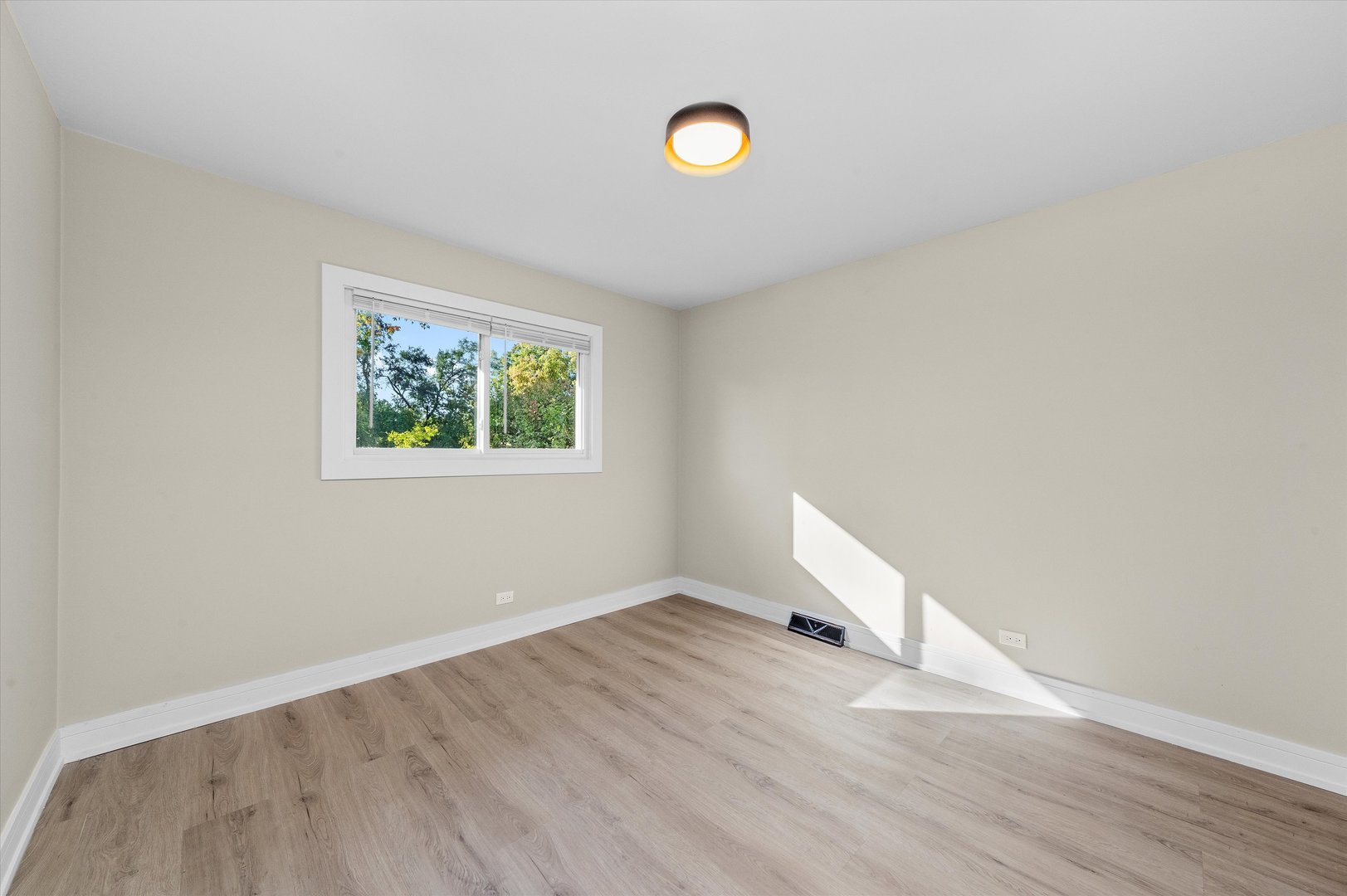 16619 Marshfield Avenue Markham, IL 60428 - Photo 12 of 41 an empty room with wooden floor and windows