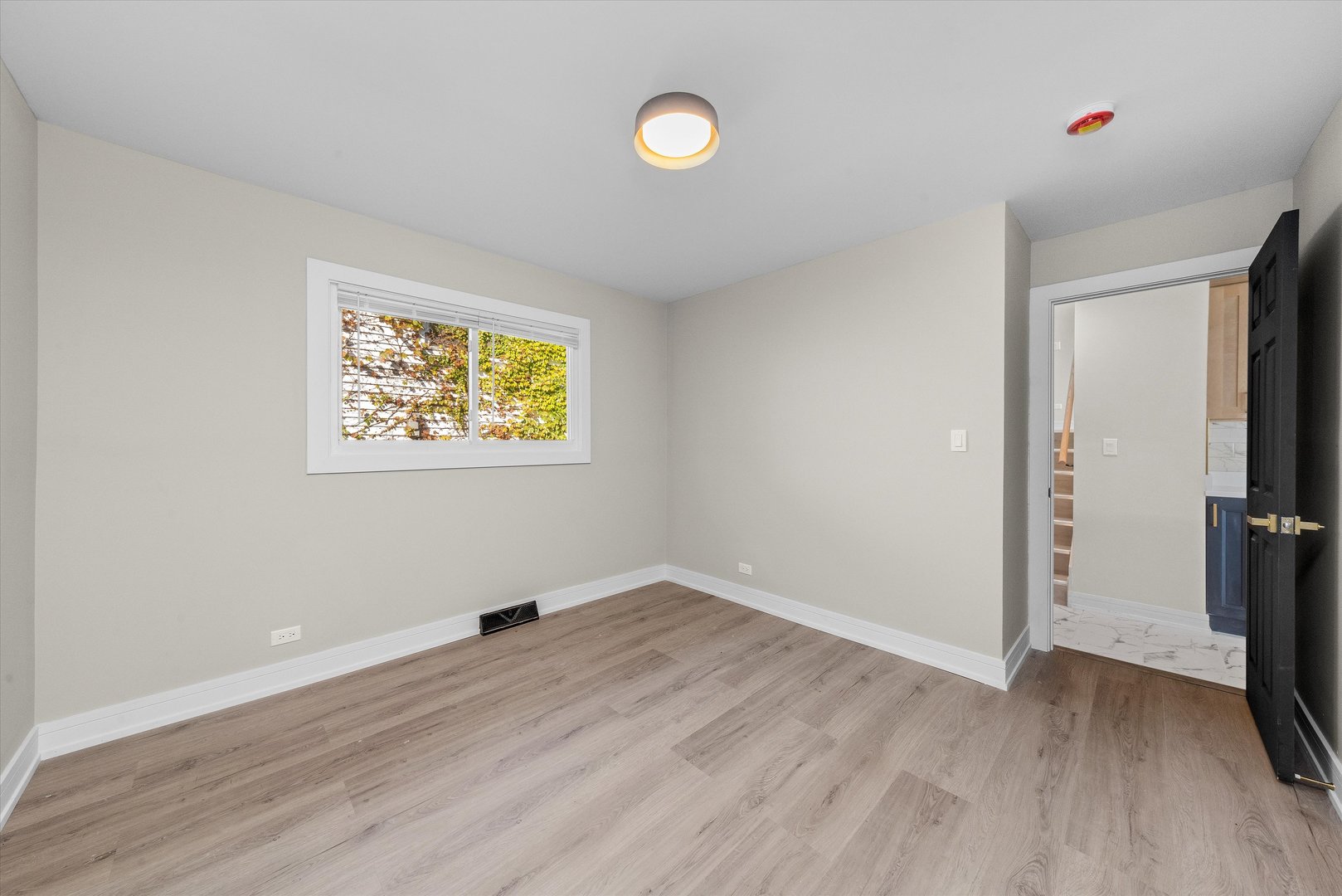 16619 Marshfield Avenue Markham, IL 60428 - Photo 17 of 41 wooden floor in an empty room with a window